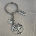 Silver keychain with tree of life design and 'FAMILY' tag